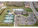 Aerial view of community amenities including pool, tennis courts, and parking at 3107 Mountain Spruce Ter, Wesley Chapel, FL 33543
