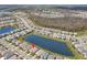Beautiful aerial view of the home overlooking a serene lake in a well-maintained community at 3107 Mountain Spruce Ter, Wesley Chapel, FL 33543