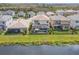 Beautiful aerial view of a home with a screened-in pool and serene lakefront views at 3107 Mountain Spruce Ter, Wesley Chapel, FL 33543
