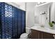Clean bathroom with a blue patterned shower curtain, sleek vanity, and modern fixtures at 3107 Mountain Spruce Ter, Wesley Chapel, FL 33543