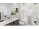 Bright bathroom featuring granite countertop, decorative mirror and framed-glass shower at 3107 Mountain Spruce Ter, Wesley Chapel, FL 33543