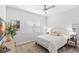 Cozy bedroom with a plush rug, white bedding, and a modern ceiling fan at 3107 Mountain Spruce Ter, Wesley Chapel, FL 33543