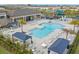 Aerial view of a luxurious community pool and lounge area, perfect for relaxation and socializing at 3107 Mountain Spruce Ter, Wesley Chapel, FL 33543