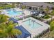 Community pool featuring a splashpad and lounge area with blue shade coverings for comfortable relaxation at 3107 Mountain Spruce Ter, Wesley Chapel, FL 33543