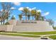 Beautiful entrance sign featuring lush landscaping, palm trees, and a stone waterfall feature at 3107 Mountain Spruce Ter, Wesley Chapel, FL 33543