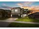Beautiful two-story home with manicured lawn, landscaped garden, and a paved driveway leading to a two-car garage at 3107 Mountain Spruce Ter, Wesley Chapel, FL 33543