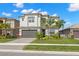 Modern two-story home featuring a two-car garage and well-manicured landscaping at 3107 Mountain Spruce Ter, Wesley Chapel, FL 33543