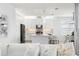 Stylish white kitchen featuring a large island, modern appliances, and an open concept layout to the living room at 3107 Mountain Spruce Ter, Wesley Chapel, FL 33543