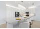 Elegant white kitchen with quartz countertops, stainless appliances, and a breakfast bar for convenient seating at 3107 Mountain Spruce Ter, Wesley Chapel, FL 33543