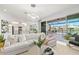 Bright, open living room with modern lighting and sliding glass doors to a private pool and patio area at 3107 Mountain Spruce Ter, Wesley Chapel, FL 33543