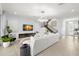 Modern living room featuring a white sofa, a fireplace, and a staircase at 3107 Mountain Spruce Ter, Wesley Chapel, FL 33543