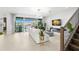 Modern living room with tile flooring, a white sofa, and a large sliding glass door at 3107 Mountain Spruce Ter, Wesley Chapel, FL 33543