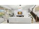 Modern living room features sleek finishes, a contemporary fireplace, and access to an outdoor patio and staircase at 3107 Mountain Spruce Ter, Wesley Chapel, FL 33543