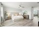 Serene main bedroom with large windows, hardwood floors, and contemporary furnishings at 3107 Mountain Spruce Ter, Wesley Chapel, FL 33543