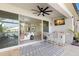 Covered patio boasts an outdoor bar, ceiling fan, and access to the home's luxurious interior at 3107 Mountain Spruce Ter, Wesley Chapel, FL 33543