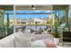 Bright living room with a white sofa, a large sliding glass door to the patio and a view of the pool at 3107 Mountain Spruce Ter, Wesley Chapel, FL 33543