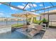 Relax in your screened-in pool and enjoy a lake view, firepit, and lounge area at 3107 Mountain Spruce Ter, Wesley Chapel, FL 33543