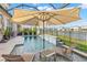 Take a dip in your screened-in pool with lounge chairs, and a view of the lake at 3107 Mountain Spruce Ter, Wesley Chapel, FL 33543