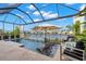 Relax in your screened-in pool and enjoy the lake view and waterfall feature at 3107 Mountain Spruce Ter, Wesley Chapel, FL 33543