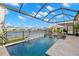 Soak in the sun in your screened-in pool that overlooks a lake and has a waterfall feature at 3107 Mountain Spruce Ter, Wesley Chapel, FL 33543