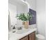 Stylish powder room with modern fixtures, decorative mirror, and elegant hand soap at 3107 Mountain Spruce Ter, Wesley Chapel, FL 33543