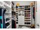 Organized walk-in closet with custom shelving, drawers, and ample storage space for shoes and bags at 3107 Mountain Spruce Ter, Wesley Chapel, FL 33543