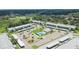 Wide aerial view showcasing buildings with parking, pool, and surrounding landscape at 313 Martha Ln # 4, Oldsmar, FL 34677