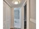 Hallway view of the bathroom with marble tile, a toilet, and a shower/tub combo at 313 Martha Ln # 4, Oldsmar, FL 34677