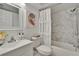 Updated bathroom with decorative shower curtain and marble surround at 313 Martha Ln # 4, Oldsmar, FL 34677