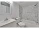 Contemporary bathroom featuring a tub and shower combination with marble tiling at 313 Martha Ln # 4, Oldsmar, FL 34677