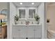 Well-lit bathroom with double vanity, sleek countertops, and a calming, minimalist design at 313 Martha Ln # 4, Oldsmar, FL 34677
