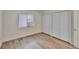 Bedroom features luxury vinyl plank flooring, window, and double closet at 313 Martha Ln # 4, Oldsmar, FL 34677