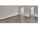Bright bedroom with wood floors and neutral walls leading to a closet and bath at 313 Martha Ln # 4, Oldsmar, FL 34677