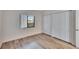 Bedroom featuring wood-look floors, a window view, and double closets at 313 Martha Ln # 4, Oldsmar, FL 34677