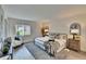Bright bedroom with a large window, neutral decor, and stylish furnishings on a soft gray rug at 313 Martha Ln # 4, Oldsmar, FL 34677