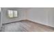 Bright bedroom features wood floors and neutral walls with a door at 313 Martha Ln # 4, Oldsmar, FL 34677