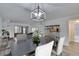 Bright dining room featuring a modern light fixture and views of the living area at 313 Martha Ln # 4, Oldsmar, FL 34677
