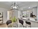 Cozy dining room area with modern light fixture, table, and views to the kitchen at 313 Martha Ln # 4, Oldsmar, FL 34677