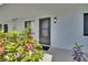 Unit 313 boasts a welcoming entrance, framed by vibrant foliage, offering a private and inviting arrival at 313 Martha Ln # 4, Oldsmar, FL 34677