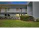 Charming condo building featuring white balconies and set against a lush green lawn at 313 Martha Ln # 4, Oldsmar, FL 34677