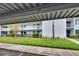 Lovely condo building featuring three stories and charming white balconies, set against a lush green lawn at 313 Martha Ln # 4, Oldsmar, FL 34677