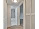 Hallway view to bathroom features marble surround and luxury vinyl plank flooring at 313 Martha Ln # 4, Oldsmar, FL 34677