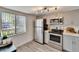 Updated kitchen with stainless steel appliances, light grey cabinetry, and laminate flooring at 313 Martha Ln # 4, Oldsmar, FL 34677