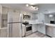 Bright kitchen features stainless appliances, light grey cabinets, and white countertops at 313 Martha Ln # 4, Oldsmar, FL 34677