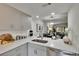 Contemporary kitchen with stone counters and stainless steel appliances open to living area at 313 Martha Ln # 4, Oldsmar, FL 34677