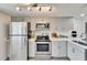 Updated kitchen with stainless steel appliances, gray cabinets, and a stylish microwave at 313 Martha Ln # 4, Oldsmar, FL 34677