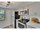 Modern kitchen featuring stainless steel appliances, light gray cabinets and stone countertops at 313 Martha Ln # 4, Oldsmar, FL 34677