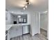 Modern kitchen featuring stainless steel appliances, light grey cabinets, and open living space at 313 Martha Ln # 4, Oldsmar, FL 34677