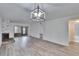 Bright living room features wood floors, fireplace, and a modern light fixture creating a cozy atmosphere at 313 Martha Ln # 4, Oldsmar, FL 34677