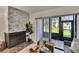 Cozy living room showcasing a stone fireplace and sliding glass doors to a screened-in porch at 313 Martha Ln # 4, Oldsmar, FL 34677
